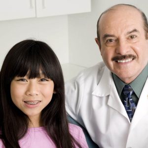 Smiling dentist with patient